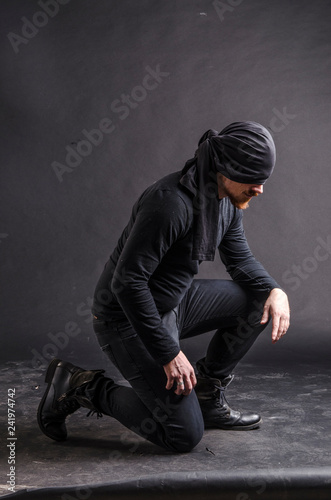 Portrait of a masked super hero on black background.