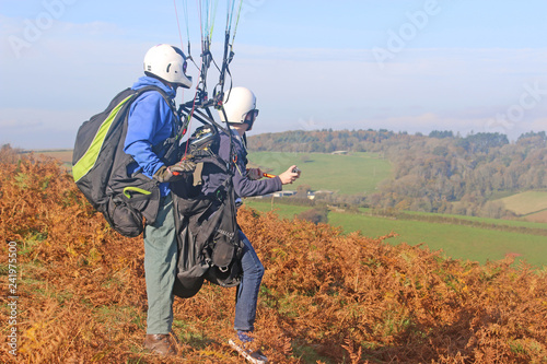 Tandem paraglider preparing to launch