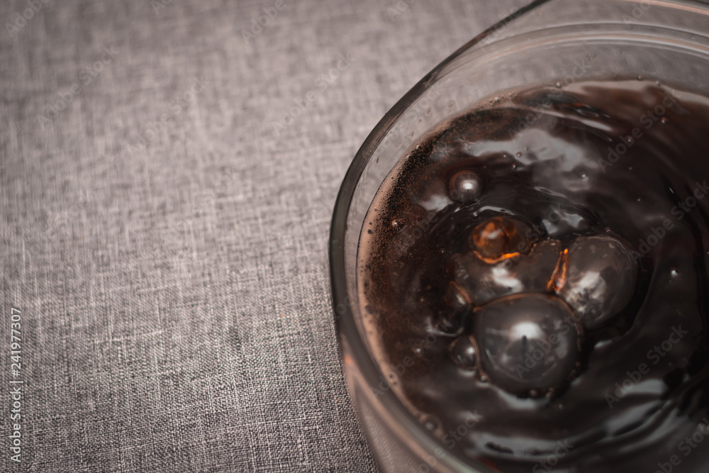 boiling dark liquid with smoke in bubbles in a glass bowl on a gray background boiling dark liquid with smoke in bubbles in a glass bowl on a gray background