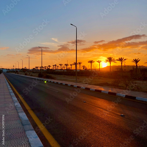 Obraz na plátně beautiful red-orange sunset on the roadway of the city of Sharm el-Sheikh in Egy