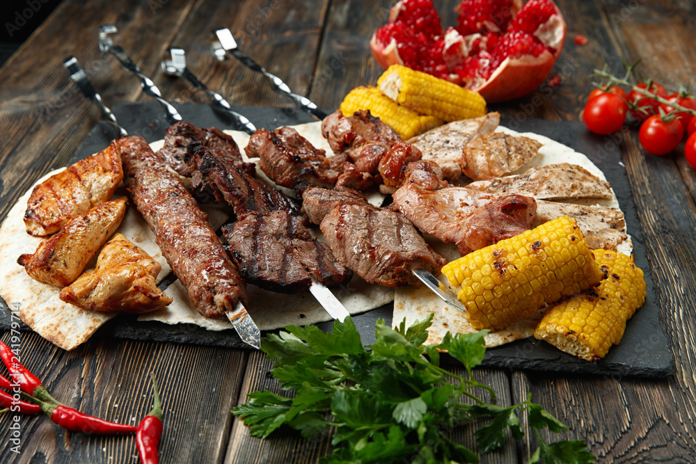 Assortment various barbecue food grill meat, bbq party fest - shish kebab,  sausages, grilled meat fillet, fresh vegetables, sauces, spices, dark rusty  concrete table, above copy space Stock Photo | Adobe Stock