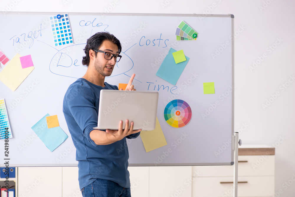 Fototapeta premium Young handsome designer working at the project