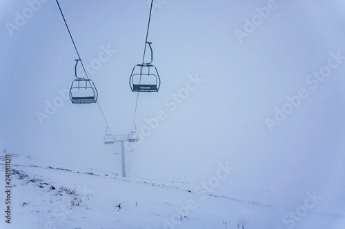 Ski lifts going over the mountain near a ski resort 