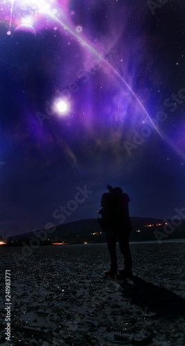 Couple looking to amazing night sky