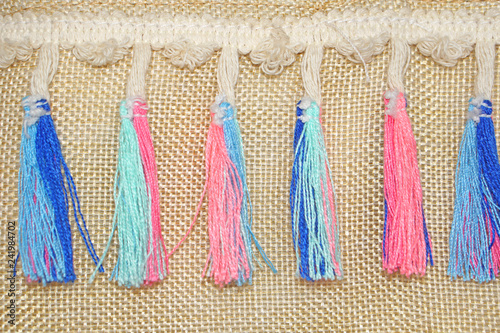 sack clothes with tussle decoration on it
 