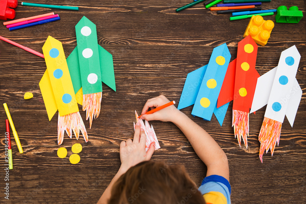 preschool Child in creativity in the home. Happy kid makes rockets from paper. Children's creativity. Creative children play with craft.
Tools and materials for children's art creativity on table.