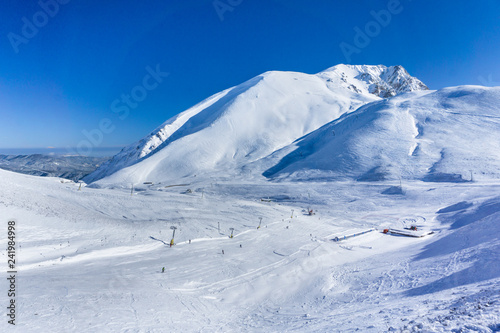 Winter landscape in a sunny day on the snow covered Velouchi mountain in Greece © Haris Andronos