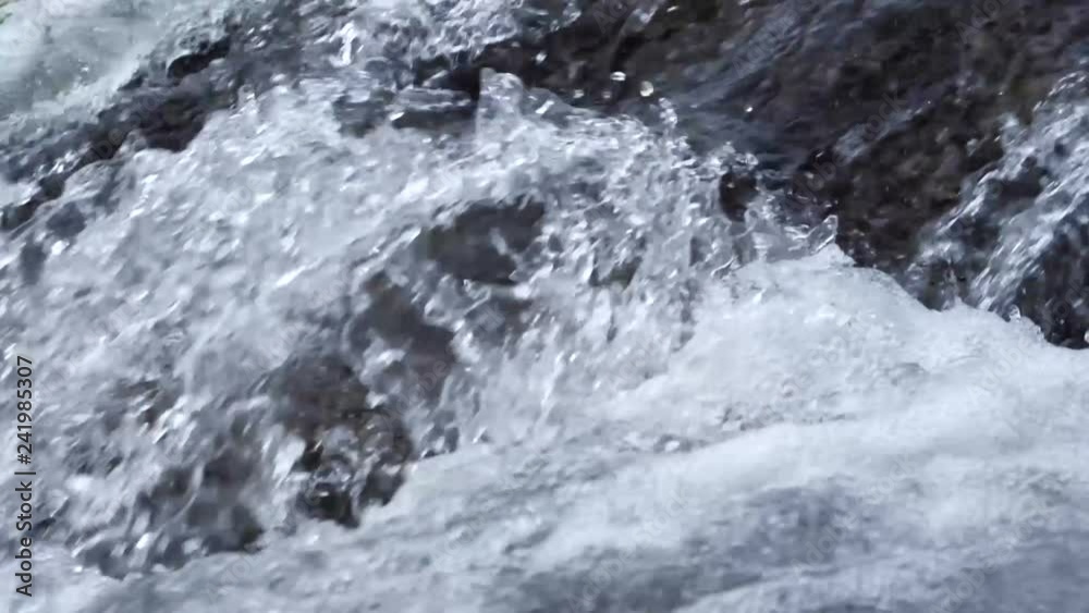 Crystal water from the waterfall with ice in winter time. Close up slow motion footage. Crystal water from the waterfall with ice in winter time. Close up slow motion footage.