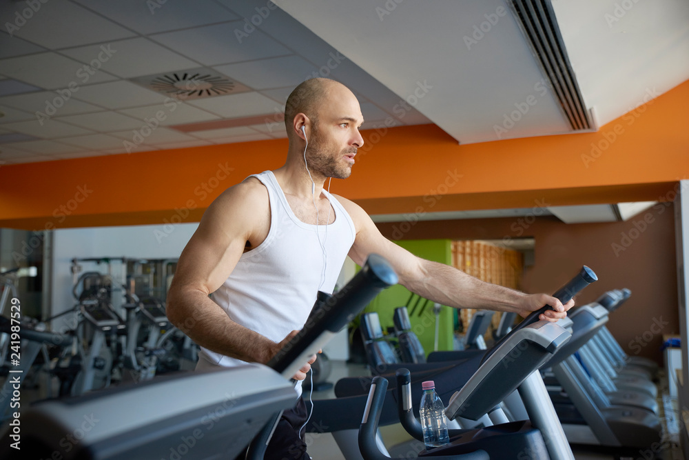 Fototapeta premium Man doing cardio training on treadmill