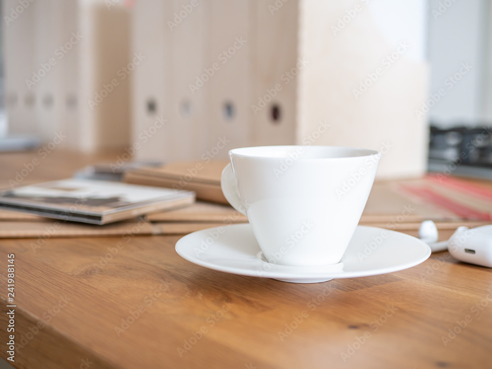 Coffee on a desk. In background work environment. Coffee on a desk. In background work environment.