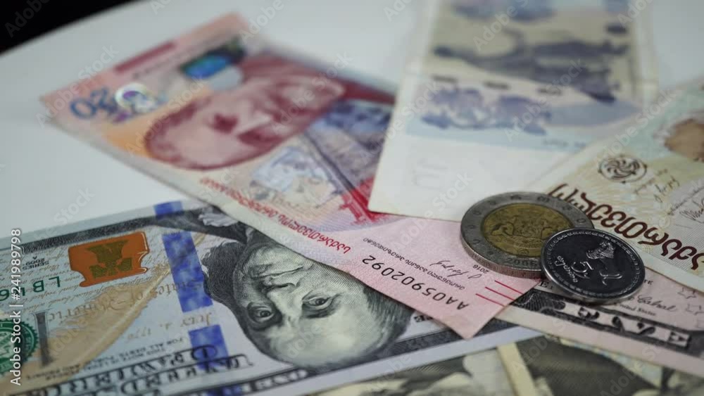 Georgian money and dollars on rotating table. 4K Georgian money and dollars on rotating table. 4K