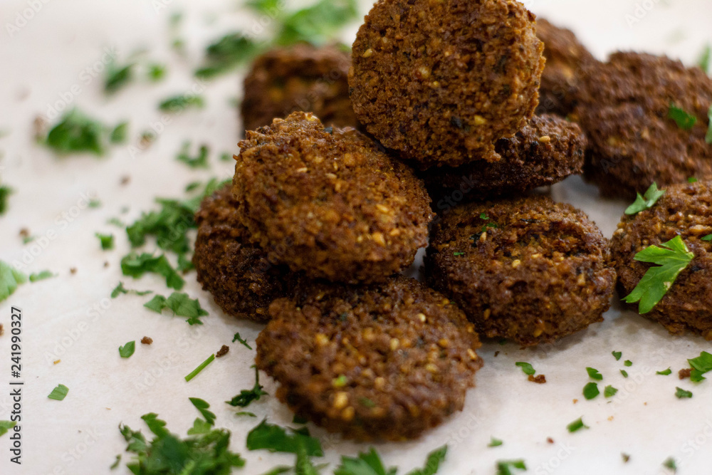 Fresh falafel with greens on white background Fresh falafel with greens on white background