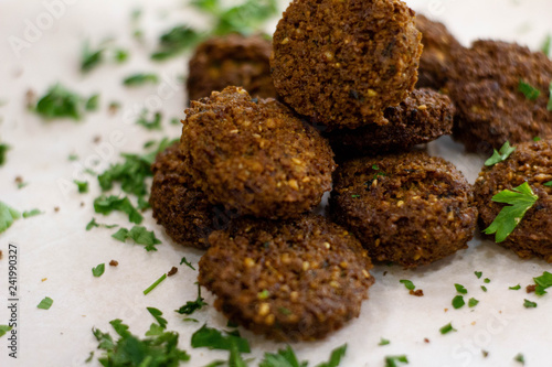 Fresh falafel with greens on white background