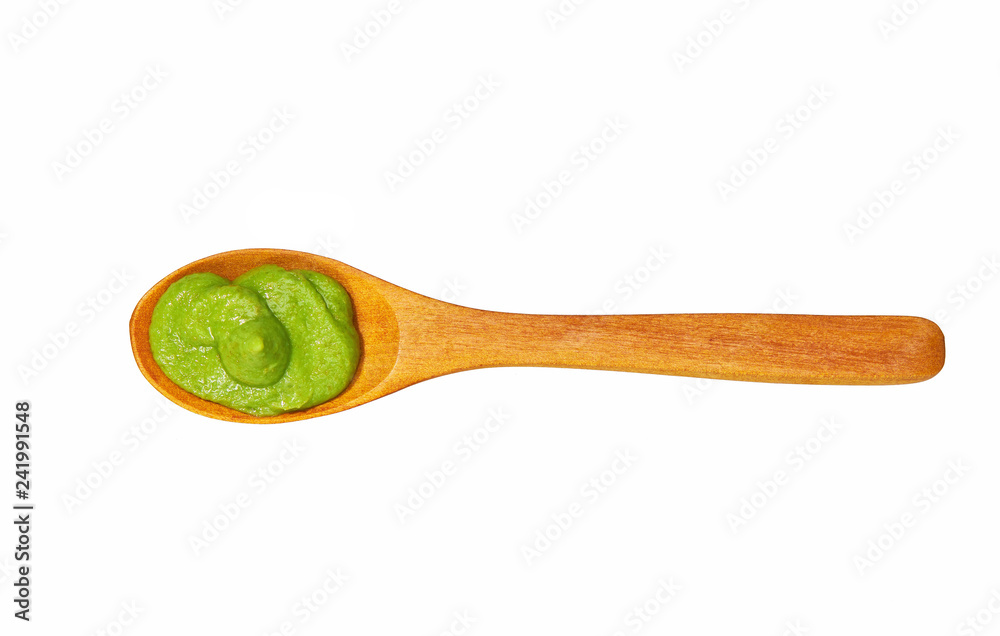 Wasabi sauce in small wooden spoon isolated on white background,top view Wasabi sauce in small wooden spoon isolated on white background,top view