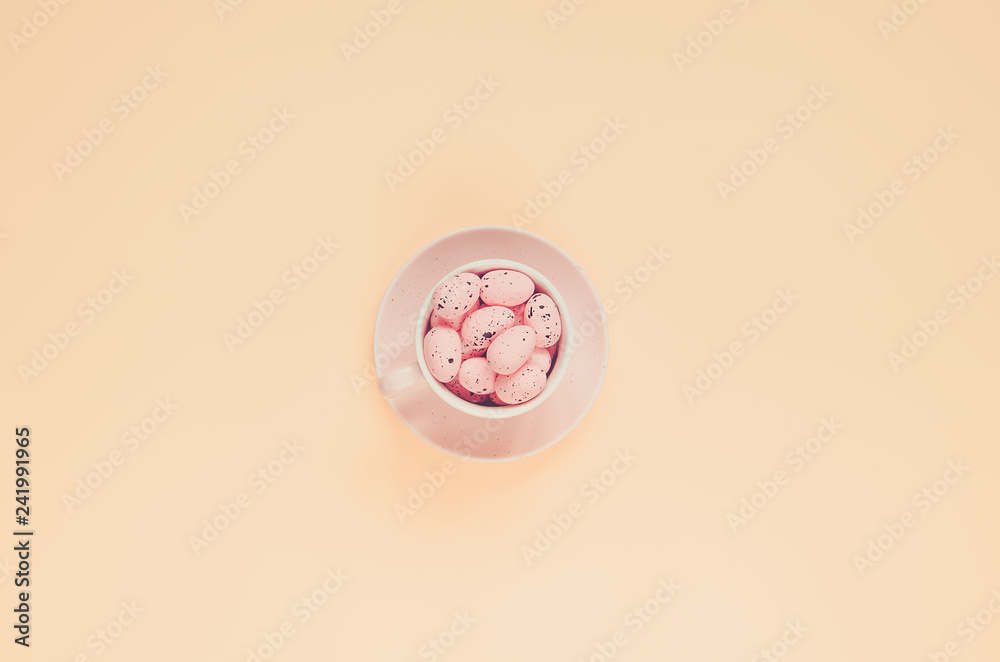 Pink easter eggs in coffee cup. Easter holiday background