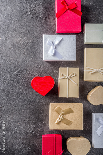 Valentines day gifts boxes background, frame for holiday greeting card background, dark concrete table flat lay, top view, copy space banner
