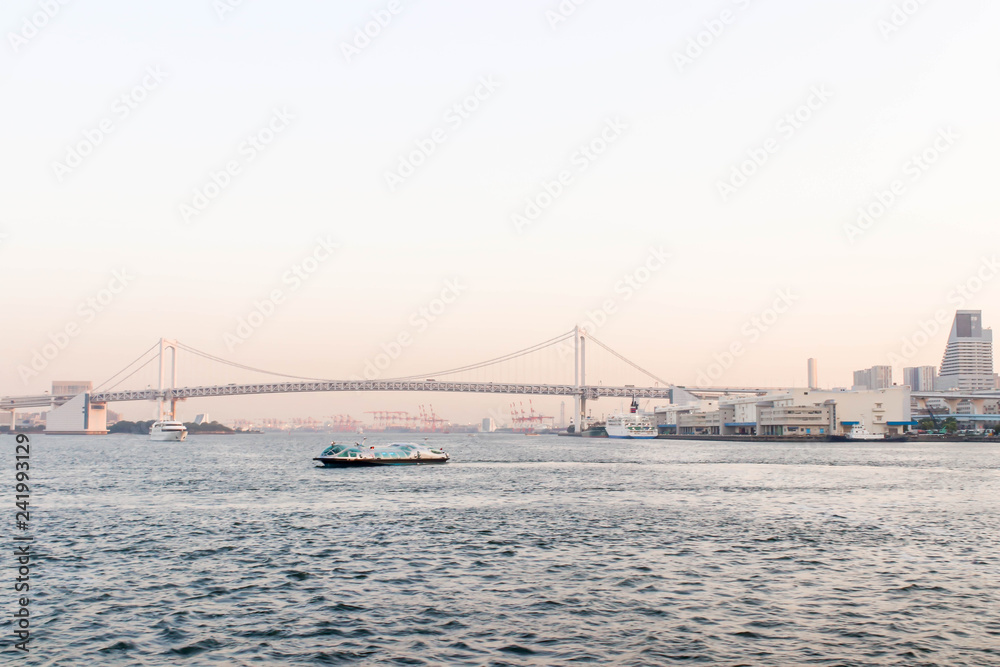 View of rainbow bridge and one boat at sumida river viewpoint in tokyo