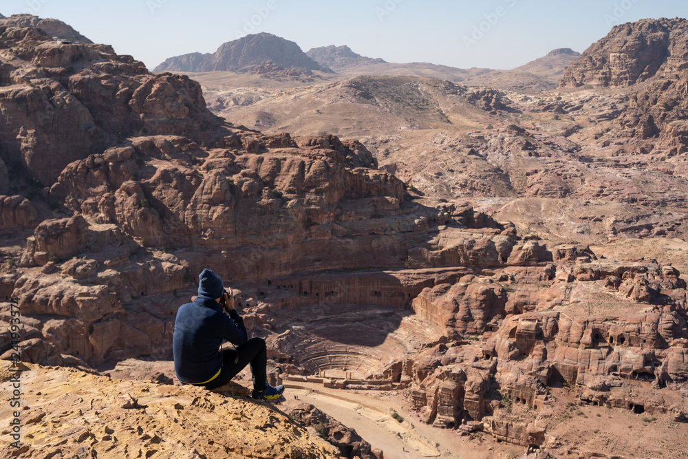 Tourist take picture and enjoy view of Roman theater in Petra ancient city, Jordan Tourist take picture and enjoy view of Roman theater in Petra ancient city, Jordan