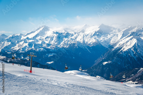Alpine landscape in the Italian Alps. Snowy mountains and ski lifts © miladrumeva