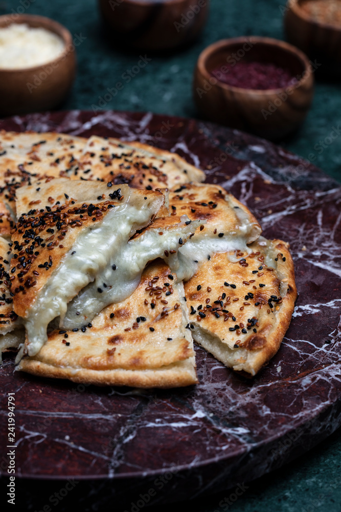 Turkish pizza served on the vooden plate Turkish pizza served on the vooden plate