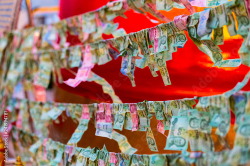 Banknotes sacrificed to Thai Angel in Bangkok, Thailand