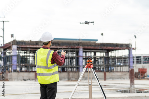 Drone operated by construction worker on building site