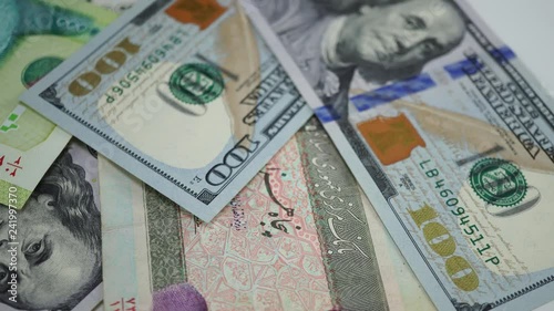 Wallpaper Mural Iranian rial and dollars on rotating table. Portrait of Khomeini on Iranian money. 4K Torontodigital.ca