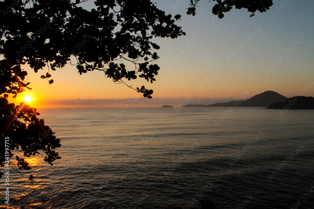 Sunrise, Ubatuba, Sao Paulo, Brazil - Paradise tropical beach with white sand, blue and calm waters, without people on a sunny day and blue sky of the Brazilian coast in high resolution
