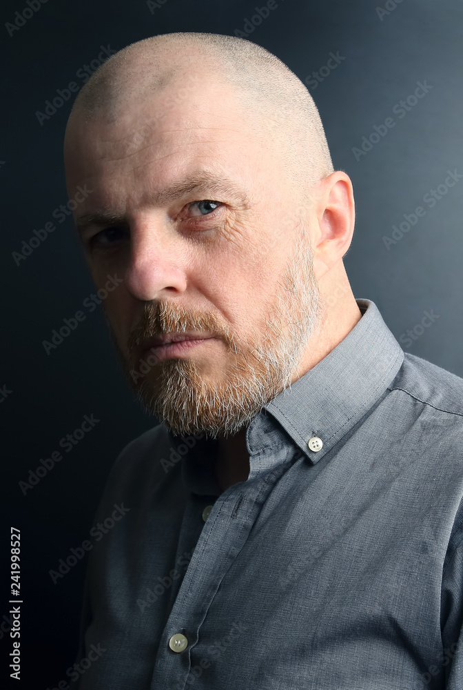 portrait of a bearded man on a dark background