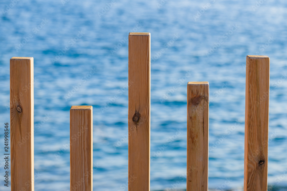 Decorative fence of wooden bars on the waterfront near the village of Alcala.  Tenerife. Canary Islands..Spain