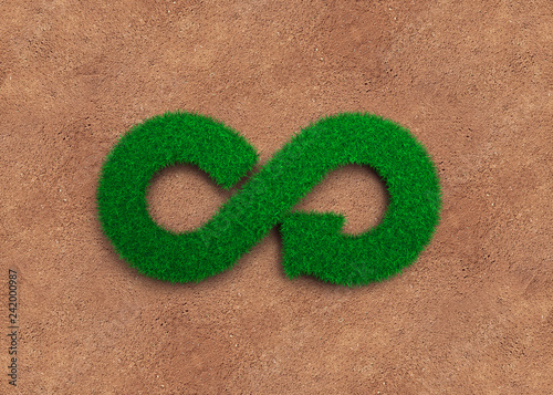 ECO and circular economy concept. The green grass in form of arrow infinity recycling symbol and soil background.