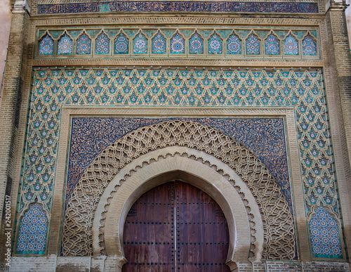 The Bab el-Mansour gate   Bab Mansour Laleuj   decorated with very impressive zellij  mosaic ceramic tiles  at the El Hedim square. The entrance to the old city of Meknes  Morocco