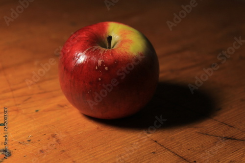 red apple on wooden table