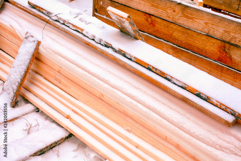 Heap of lumber covering in snow. Heap of lumber covering in snow.