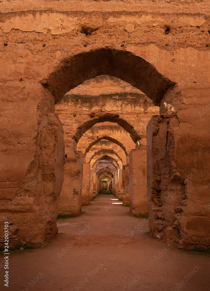 The Ancient ruined arches of the massive Royal Stables and Granaries of Moulay Ismail in the Imperial City of Meknes, Morocco near Fes. Miknasa