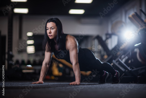 athletic woman doing push-ups in the gym. Woman doing yoga