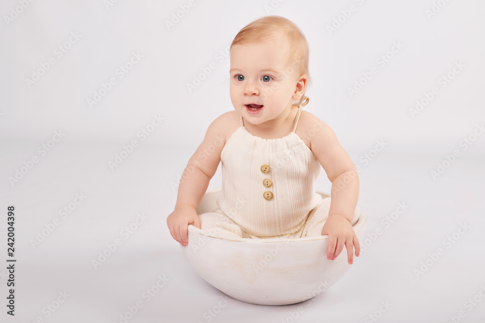 Toddler boy in an Easter bunny costume on a light background with Easter eggs Toddler boy in an Easter bunny costume on a light background with Easter eggs