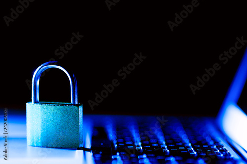 Padlock on laptop. Internet data privacy information security concept. Antivirus and malware defense. Blue toned