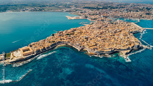 Aerial panoramic view of Ortigia island,old town of Syracuse.Small island on Sicily,Italy.Sicilian vacation,charming Italian experience.Beautiful seaside landscape photo