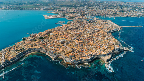 Aerial panoramic view of Ortigia island,old town of Syracuse.Small island on Sicily,Italy.Sicilian vacation,charming Italian experience.Beautiful seaside landscape