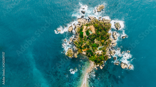 Aerial view of charming coastal Mediterranean small town on Sicily island, Taormina. Beaches of Taormina and south Italy.Travel destination, vacation in Italy concept.Aerial landscape of Bella Isola photo