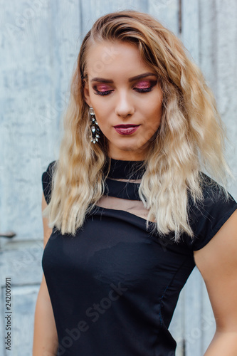 Attractive lady with blond hair and bright makeup