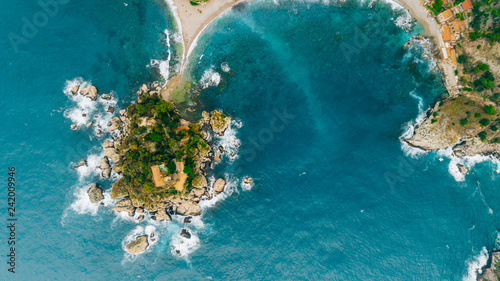Aerial view of charming coastal Mediterranean small town on Sicily island  Taormina. Beaches of Taormina and south Italy.Travel destination  vacation in Italy concept.Aerial landscape of Bella Isola