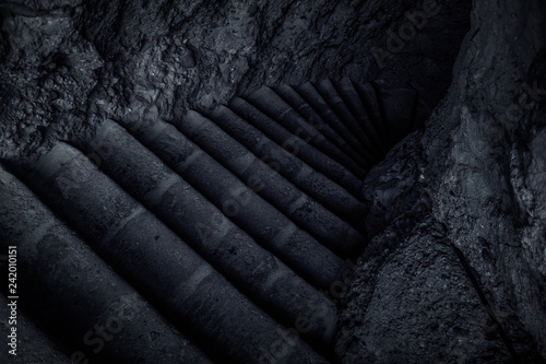 mystic stairs in twilight shadow inside stone medieval prison dungeon  photo