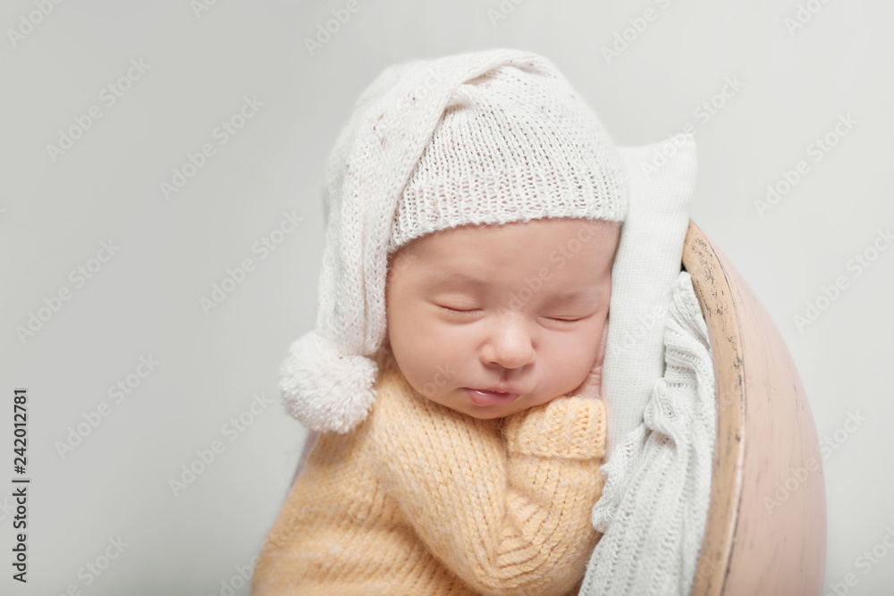 Cute newborn little boy sleeping in crib. Baby goods packaging template. Closeup portrait of newborn baby with smile on face. Healthy and medical concept. Eco conception. Nursery. Cute newborn little boy sleeping in crib. Baby goods packaging template. Closeup portrait of newborn baby with smile on face. Healthy and medical concept. Eco conception. Nursery.