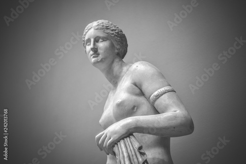 Venus goddess of love in soft light. White marble young woman isolated on black background. Aphrodite for interior posters, prints, wallpapers, design, cover. Historic heritage,sample of female beauty