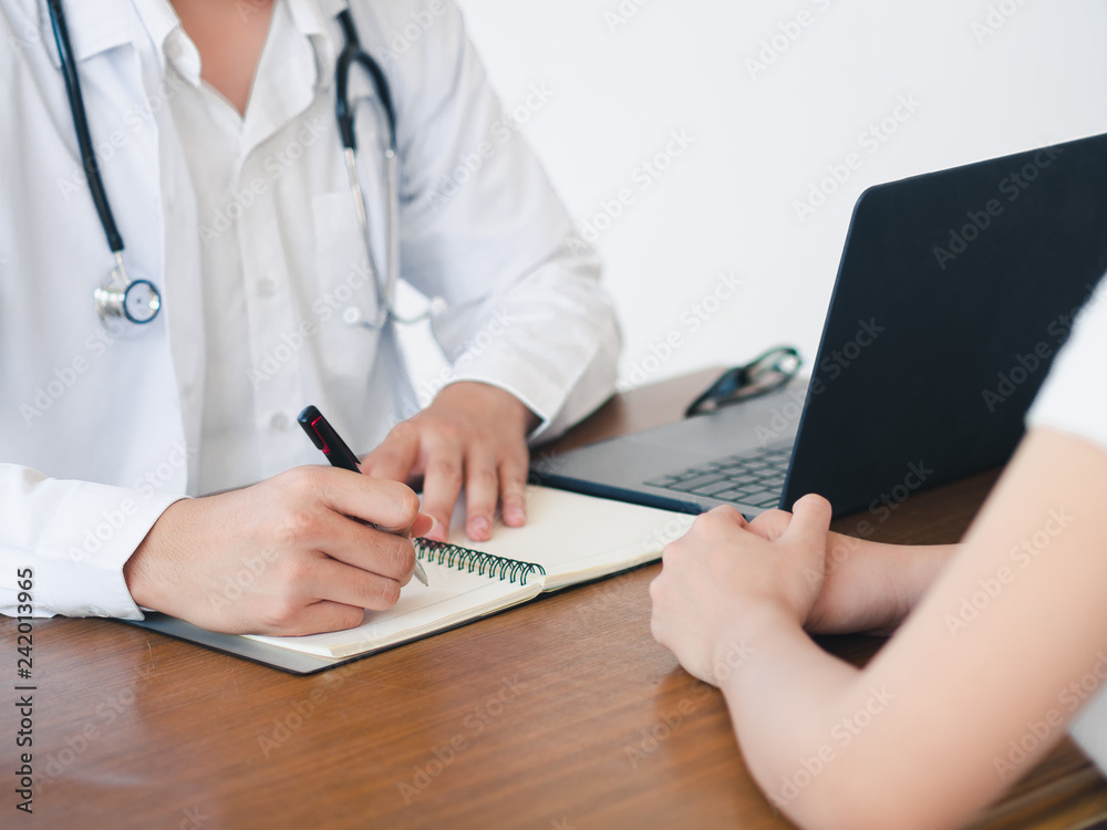 Doctor and Patient are talking in the hospital. Health care and Medical Concept. Doctor and Patient are talking in the hospital. Health care and Medical Concept.