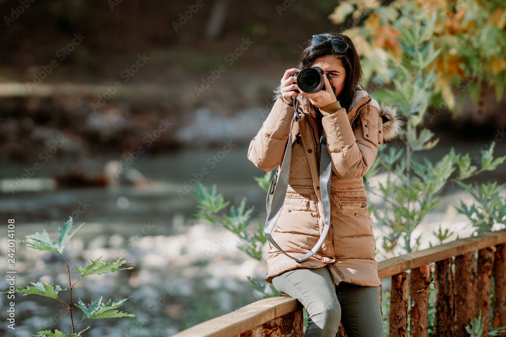 Nature Photographer taking pictures outdoors during trekking trip Nature Photographer taking pictures outdoors during trekking trip