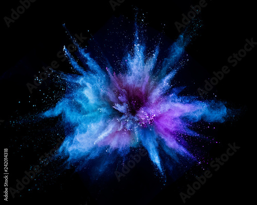 Foto Explosion of colored powder on black background