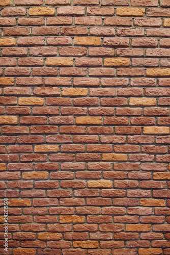 Vertical Red brick wall texture grunge background with vignetted corners.